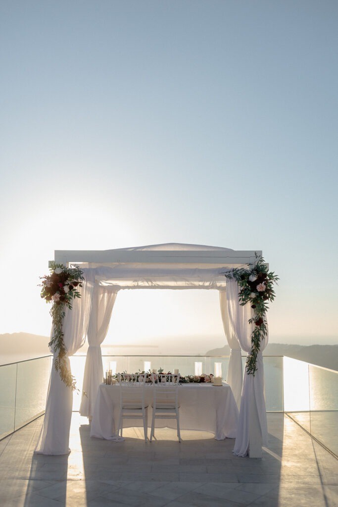 Intimate dinner setup for elopement in Santorini overlooking caldera