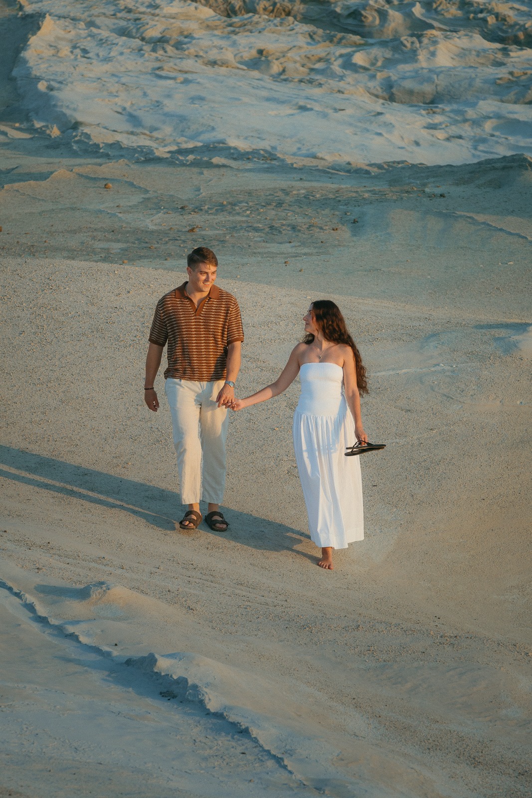 Couple at sunrise on Sarakiniko beach, photographed by a Milos photographer