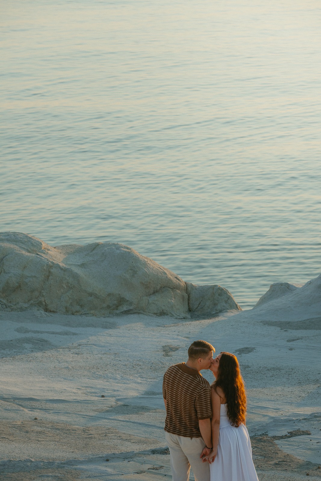 Couple at sunrise on Sarakiniko beach, photographed by a Milos photographer