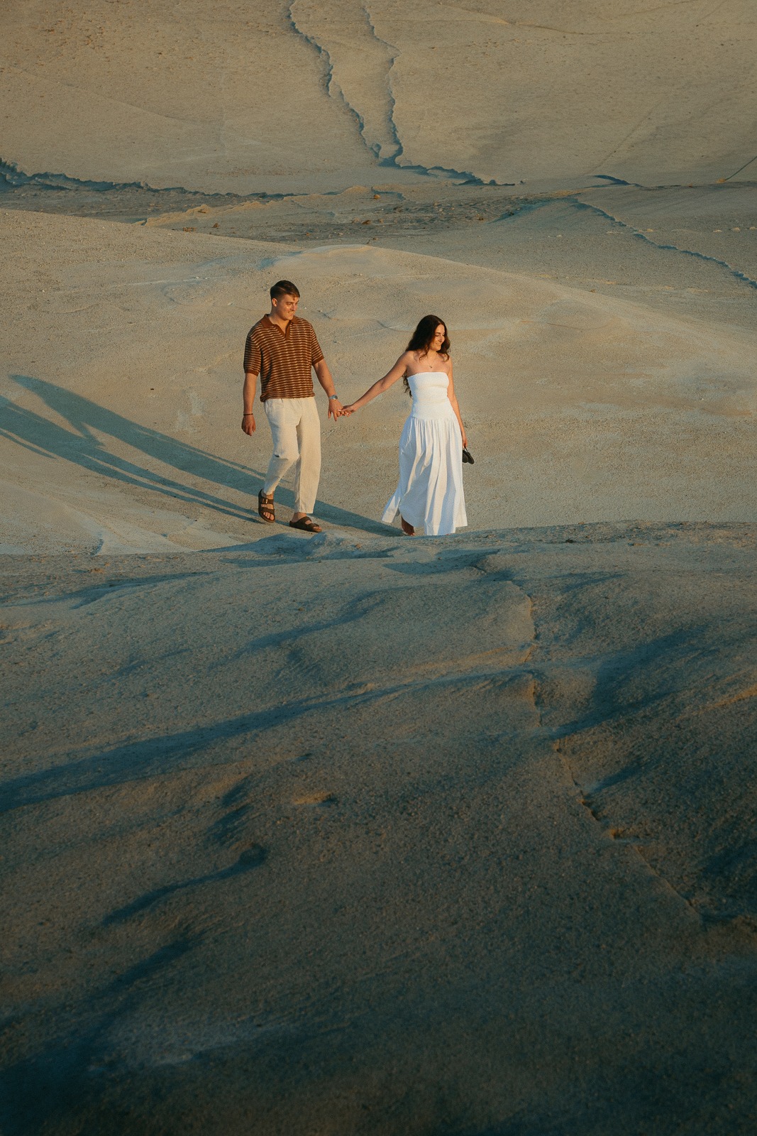 Couple at sunrise on Sarakiniko beach, photographed by a Milos photographer