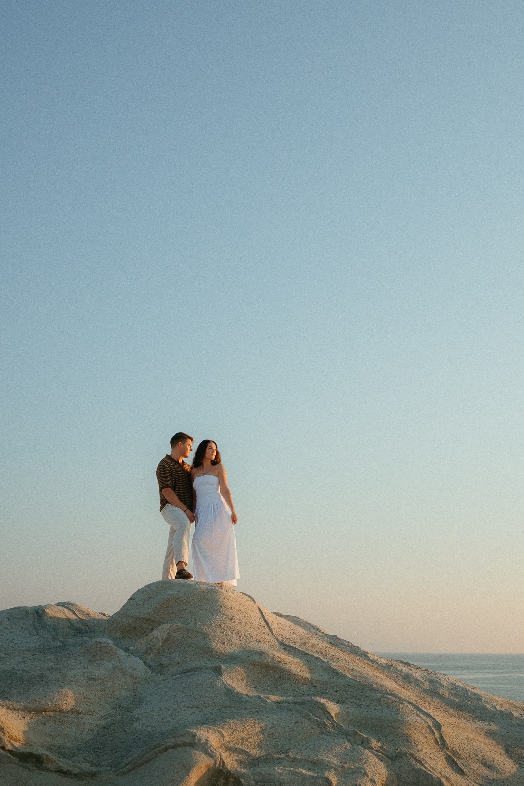 Couple at sunrise on Sarakiniko beach, photographed by a Milos photographer