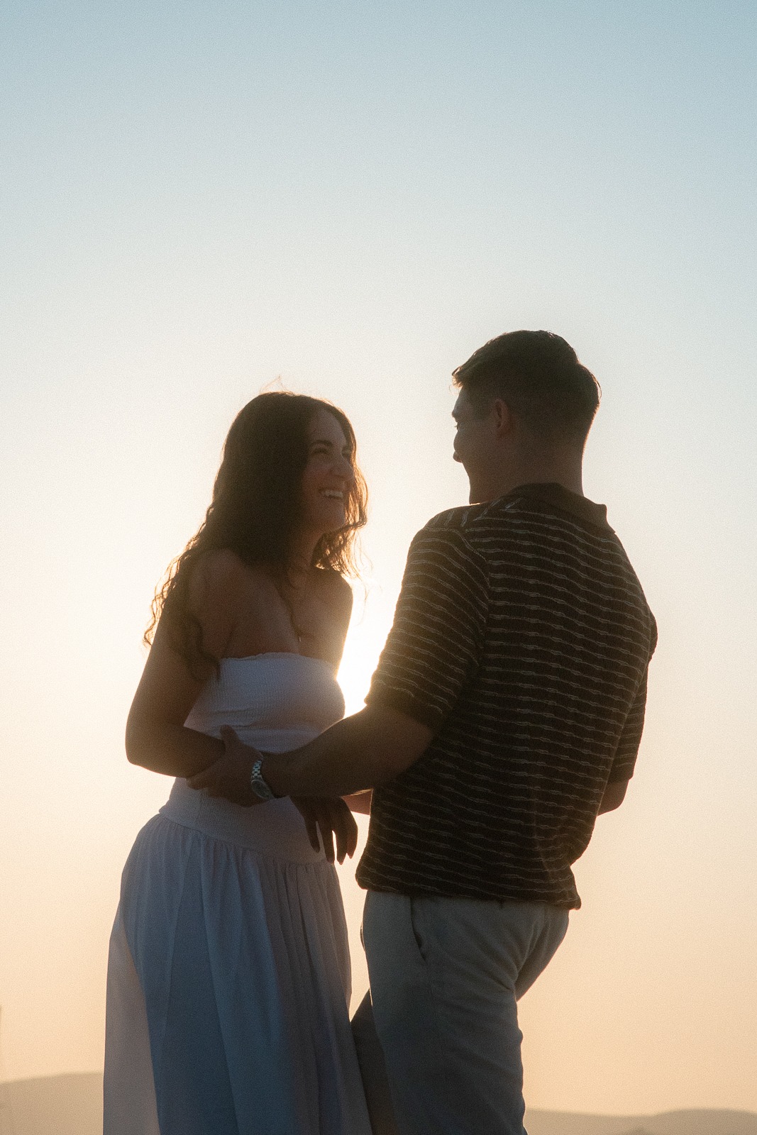 Couple at sunrise on Sarakiniko beach, photographed by a Milos photographer