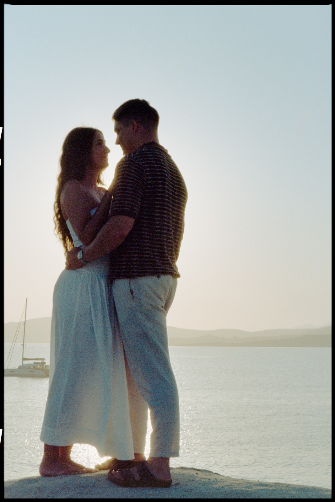 Couple at sunrise on Sarakiniko beach, photographed by a Milos photographer