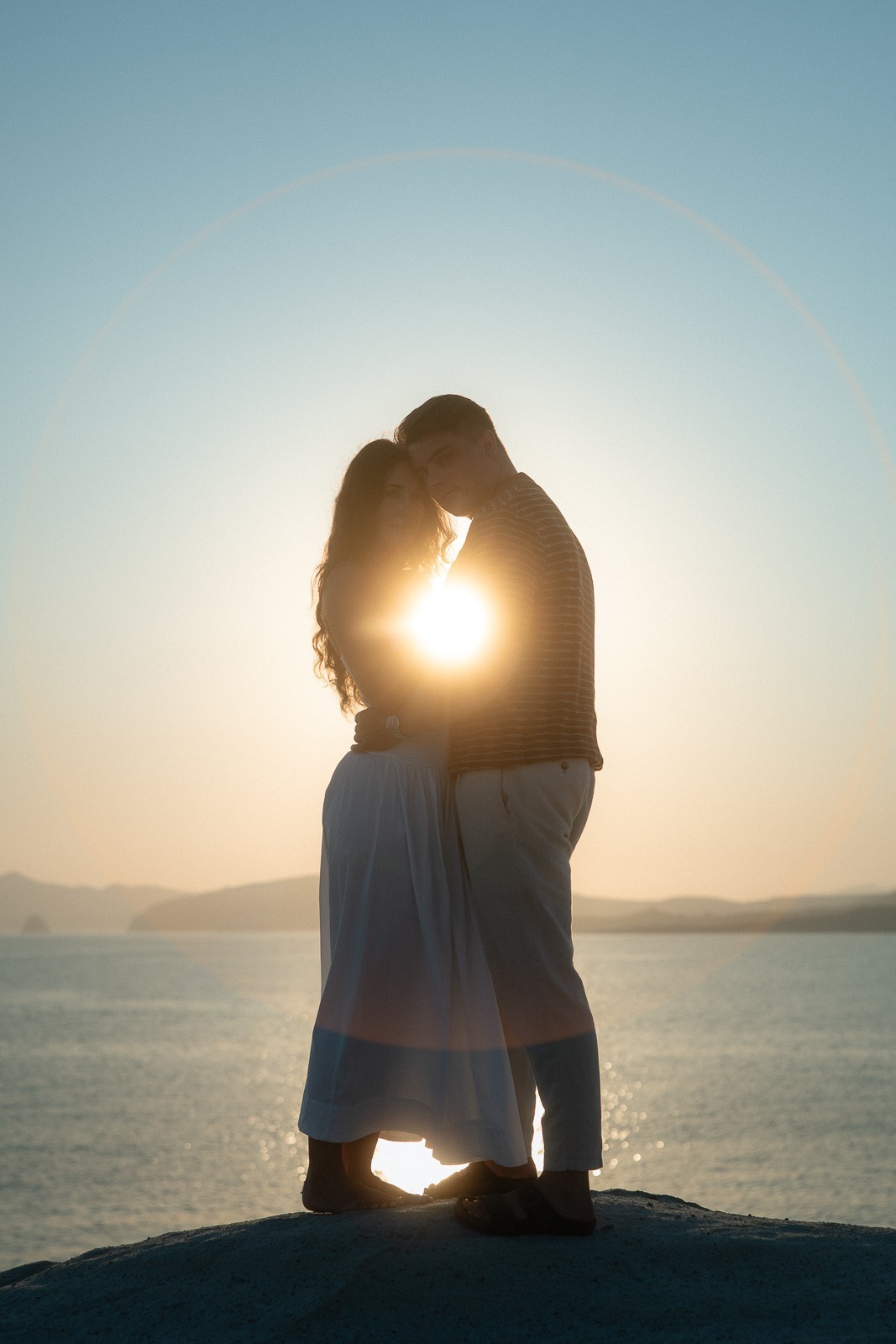 Couple at sunrise on Sarakiniko beach, photographed by a Milos photographer