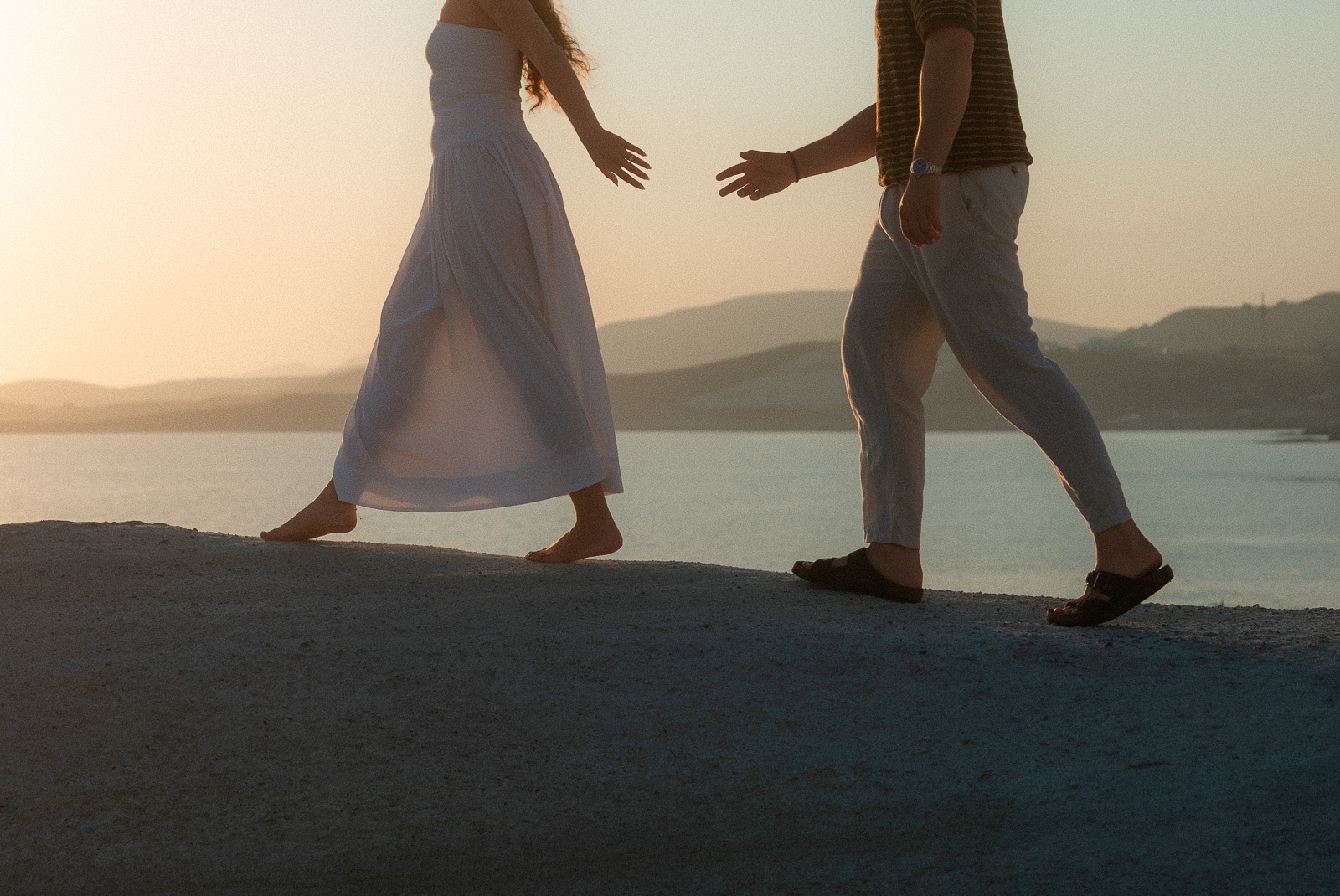 Couple at sunrise on Sarakiniko beach, photographed by a Milos photographer