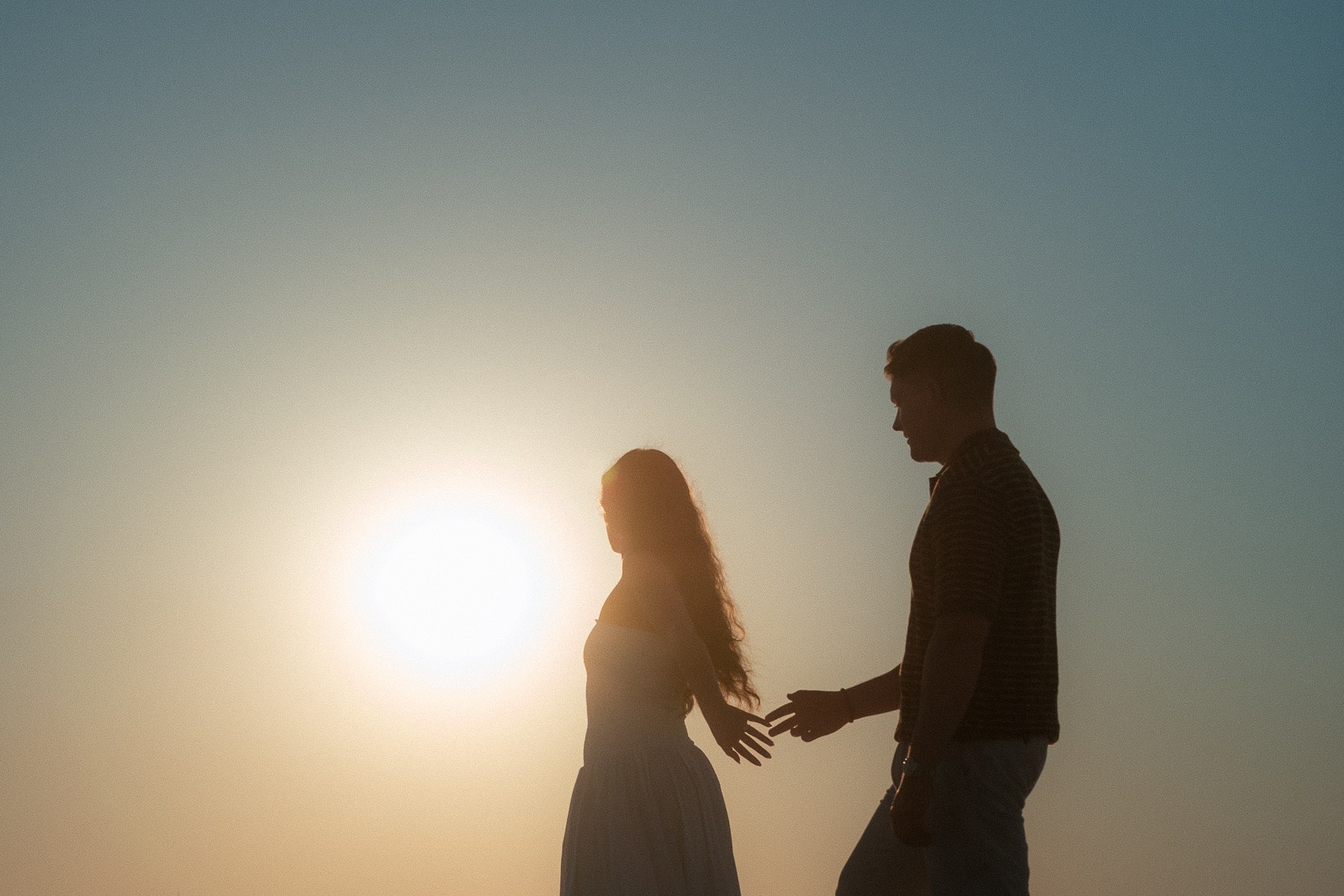 Couple at sunrise on Sarakiniko beach, photographed by a Milos photographer