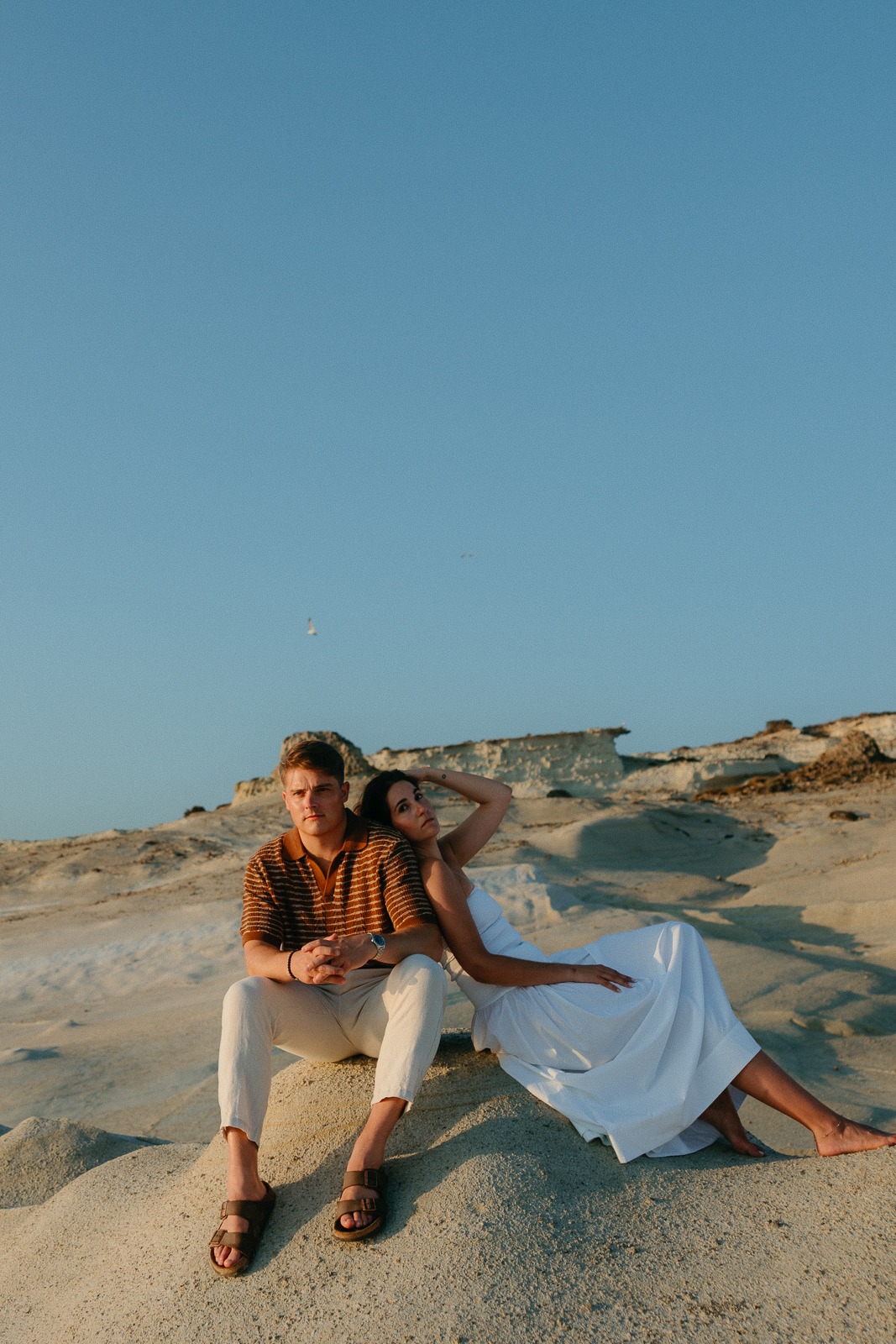 Couple at sunrise on Sarakiniko beach, photographed by a Milos photographer