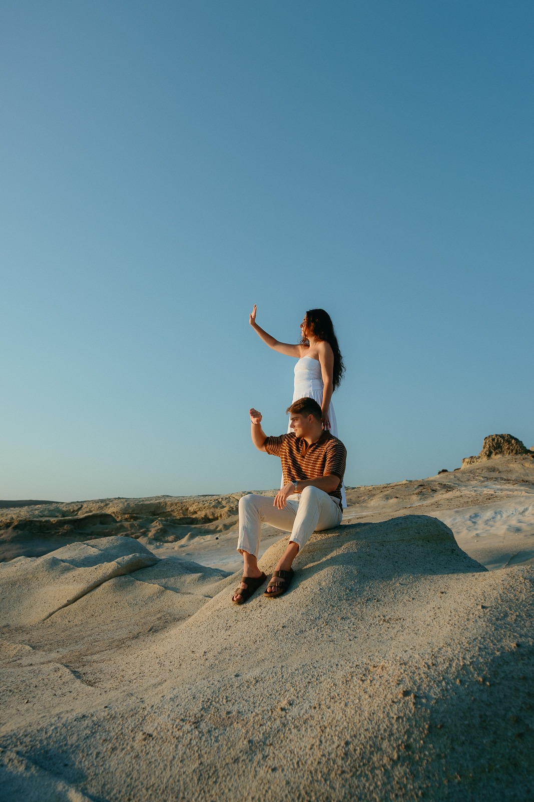 Couple at sunrise on Sarakiniko beach, photographed by a Milos photographer