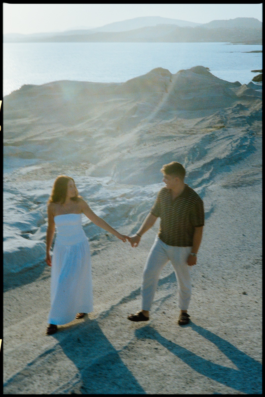 Couple at sunrise on Sarakiniko beach, photographed by a Milos photographer