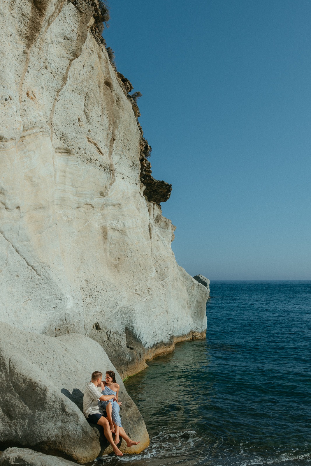 Couple at sunset on a secluded beach, photographed by a Milos photographer