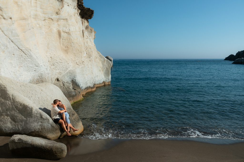 Couple at sunset on a secluded beach, photographed by a Milos photographer
