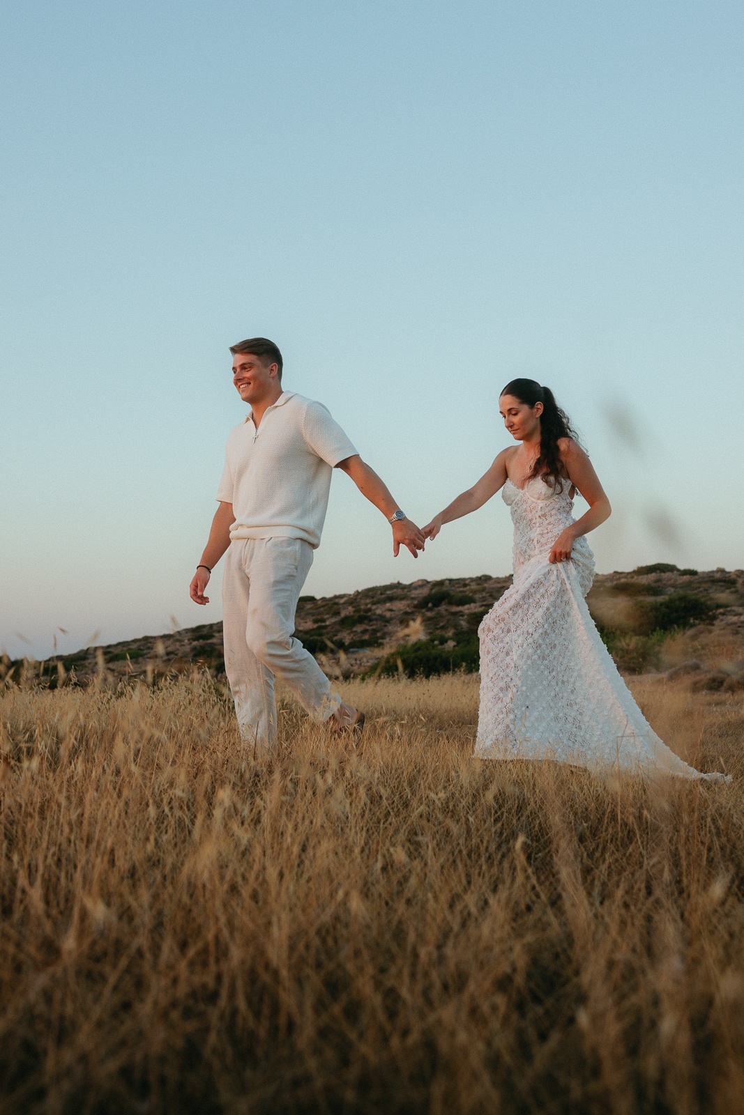 Couple at sunset on a secluded beach, photographed by a Milos photographer