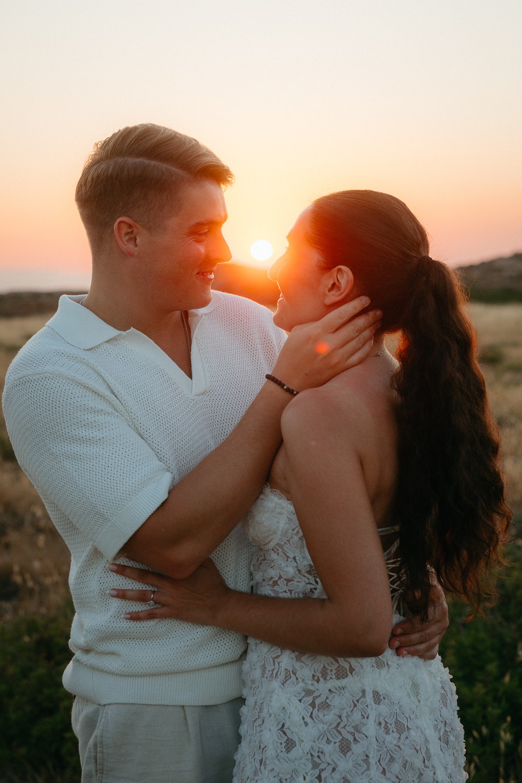 Couple at sunset on a secluded beach, photographed by a Milos photographer