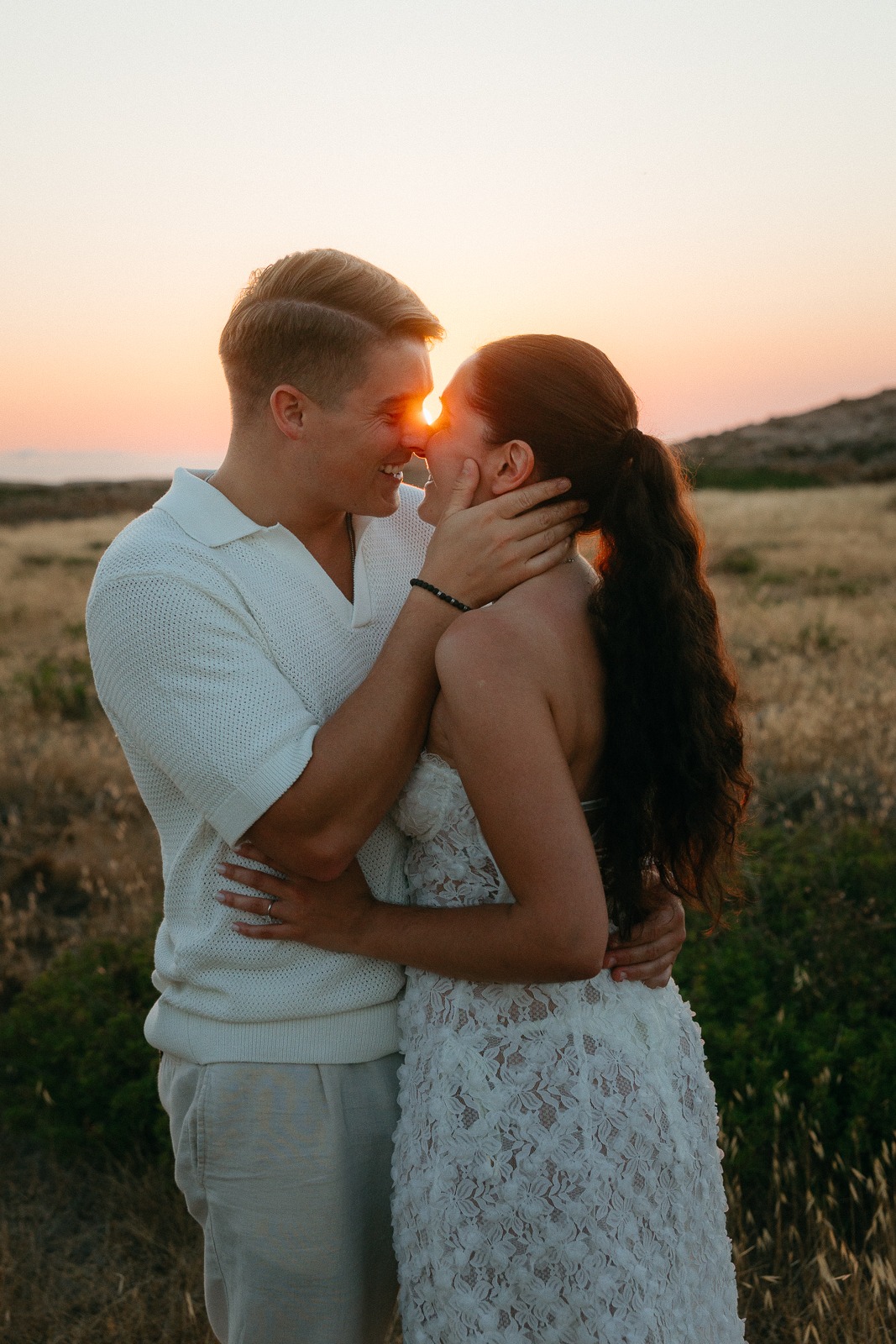 Couple at sunset on a secluded beach, photographed by a Milos photographer