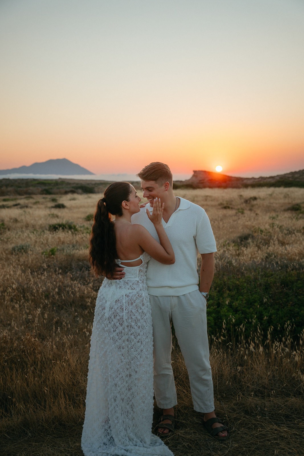 Couple at sunset on a secluded beach, photographed by a Milos photographer