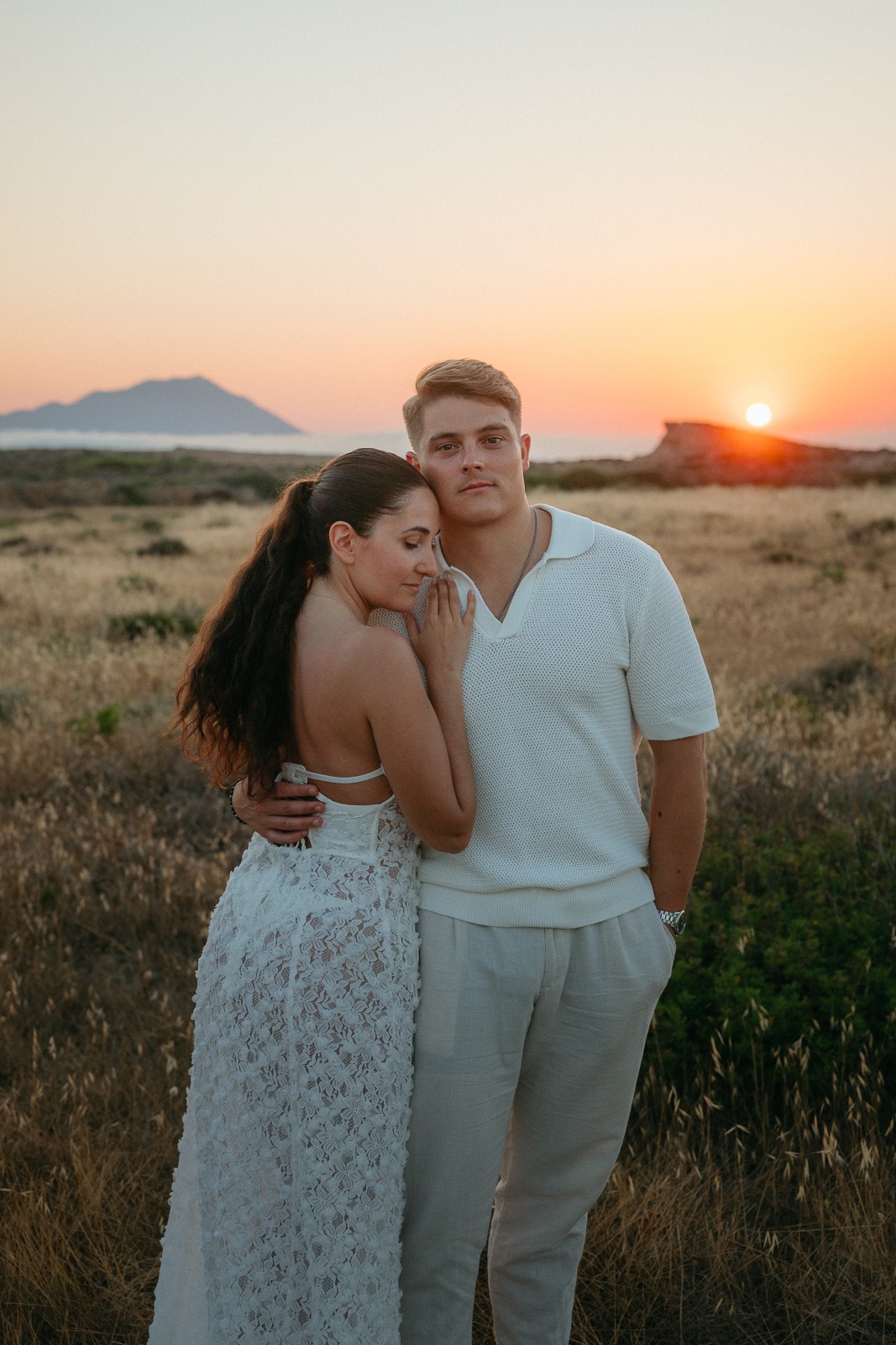 Couple at sunset on a secluded beach, photographed by a Milos photographer