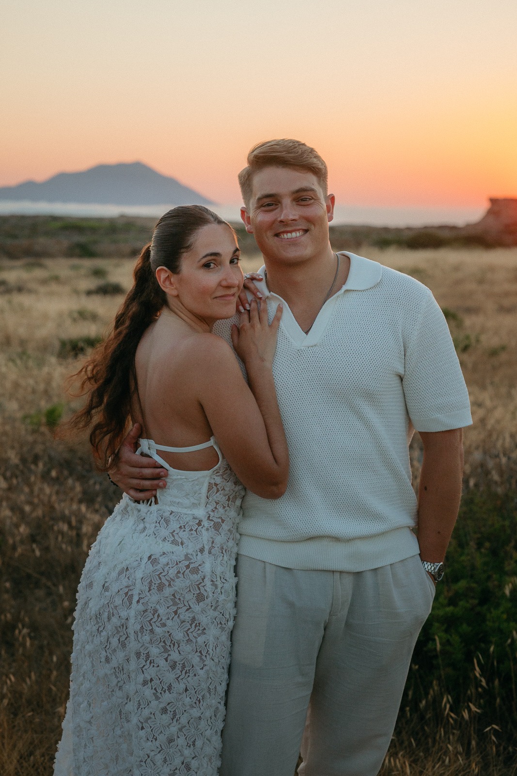 Couple at sunset on a secluded beach, photographed by a Milos photographer