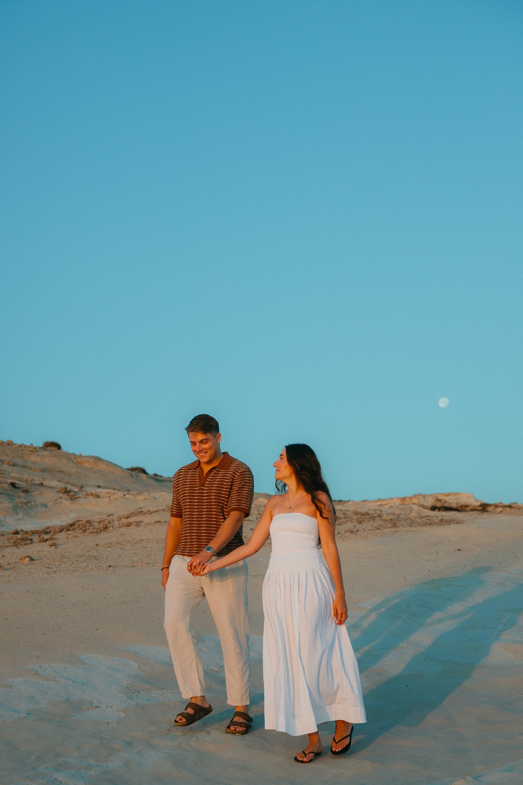 Couple at sunrise on Sarakiniko beach, photographed by a Milos photographer