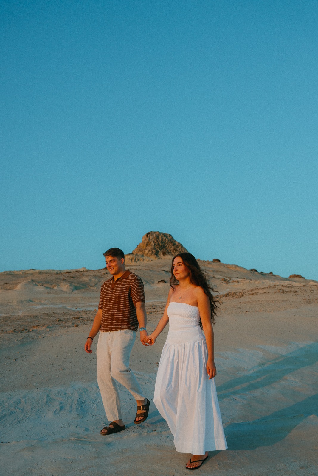 Couple at sunrise on Sarakiniko beach, photographed by a Milos photographer