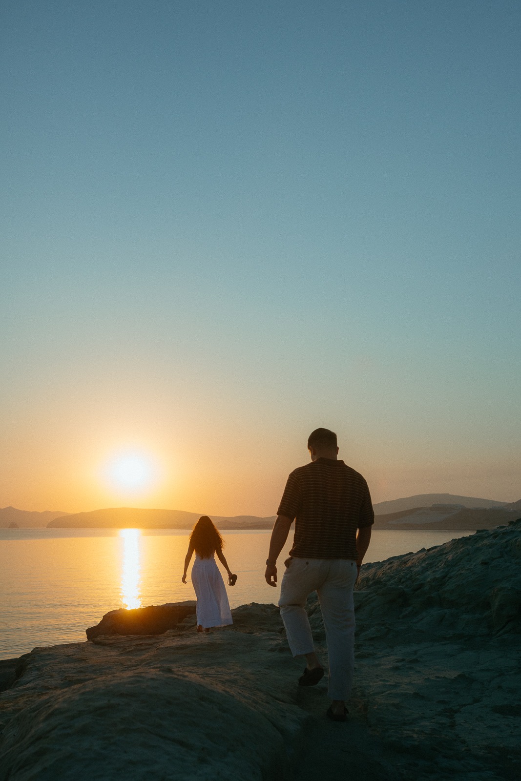 Couple at sunrise on Sarakiniko beach, photographed by a Milos photographer